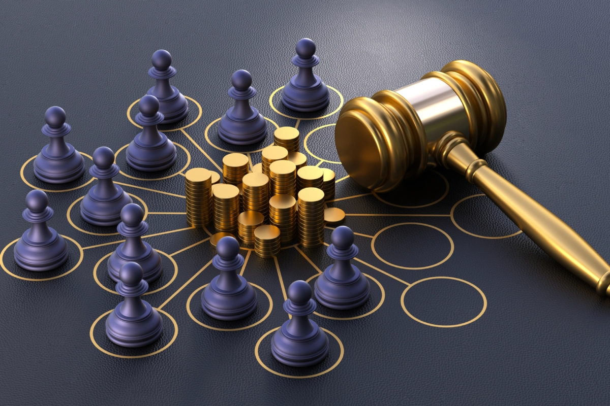 Gavel with chess pieces and stacked coins.