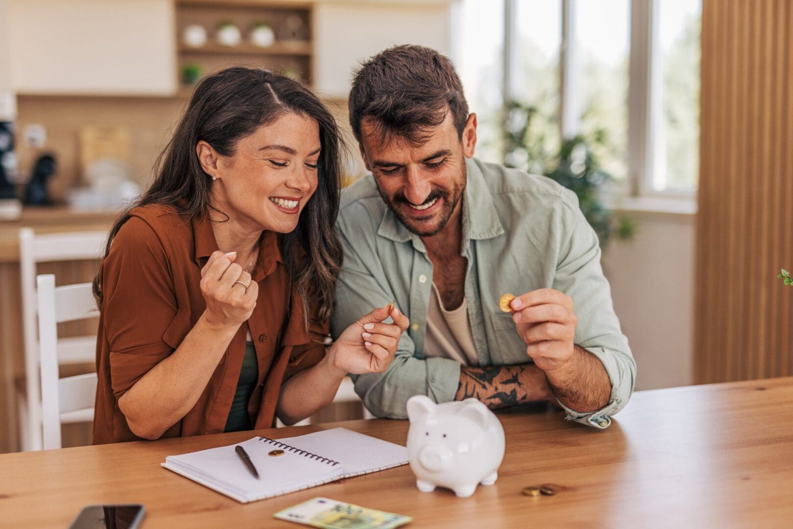Couple saving money with piggy bank.